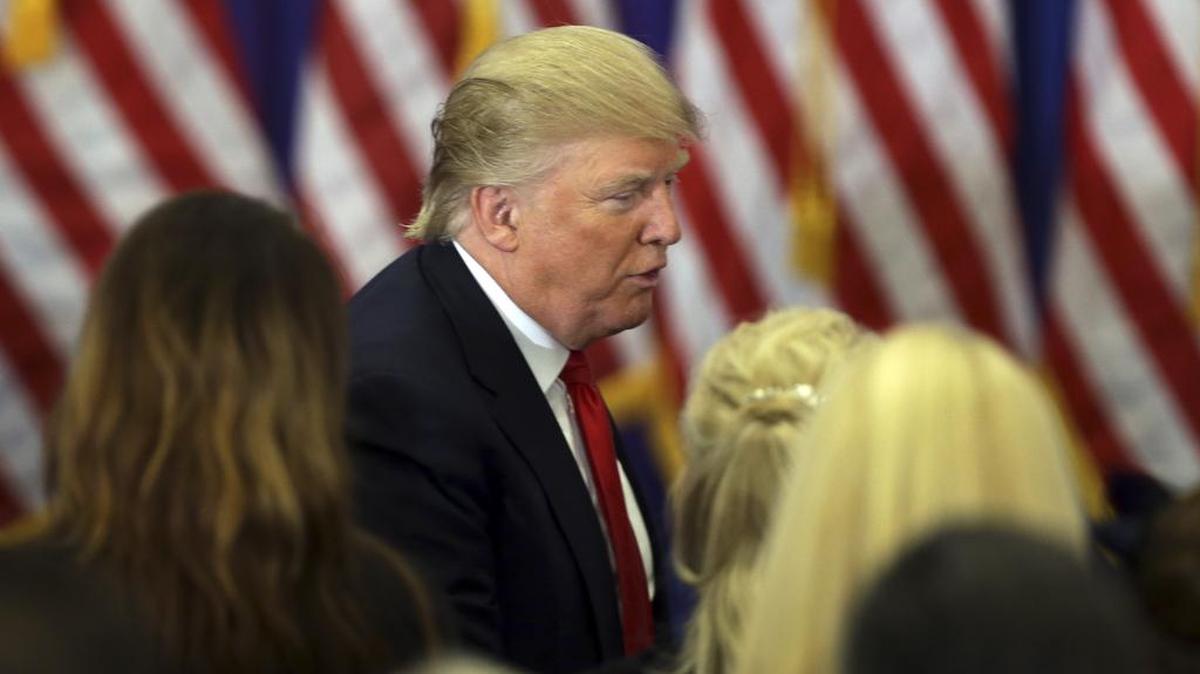 Republican presidential candidate Donald Trump talks to supporters following a news conference at the Trump National Golf Club on Tuesday, in Jupiter, Fla.