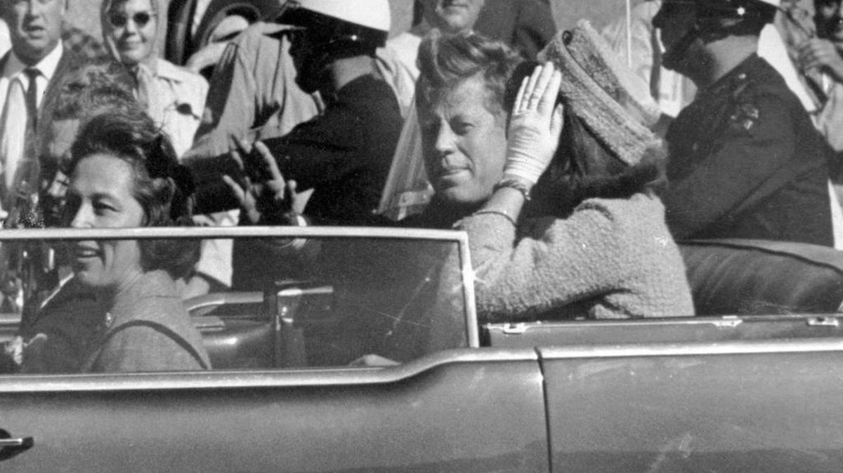 In this Nov. 22, 1963 file photo, President John F. Kennedy waves from his car in a motorcade in Dallas. Riding with Kennedy are First Lady Jacqueline Kennedy, right, Nellie Connally, second from left, and her husband, Texas Gov. John Connally, far left. (AP Photo/Jim Altgens, File)
