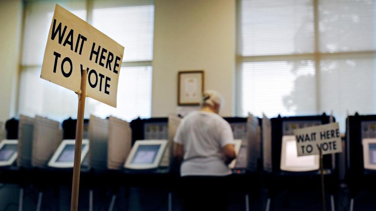 A sign greets voters before they step up to cast their ballot at a polling site in Atlanta, Ga., in 2014.