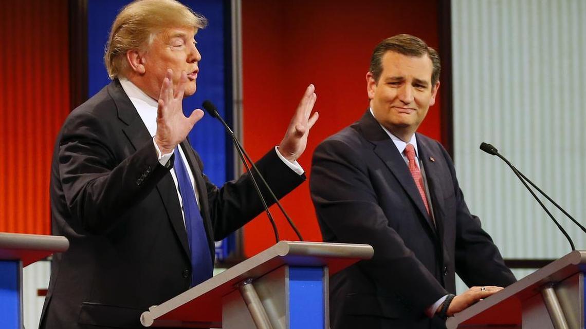 Sen. Ted Cruz, R-Texas, right, reacts as businessman Donald Trump speaks during a Republican presidential primary debate at Fox Theatre on Thursday, March 3, 2016, in Detroit.