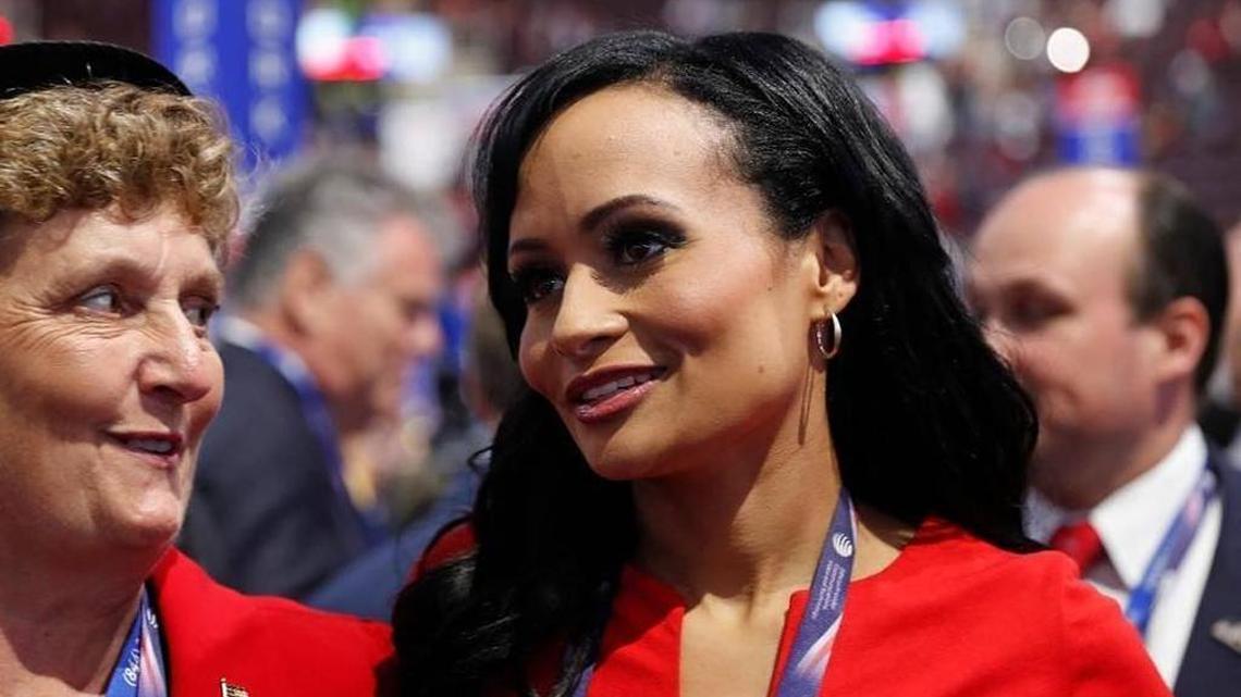 Katrina Pierson, right, talks with delegates on the convention floor during the final day of the Republican National Convention. Pierson was named to work on a pro-Trump non-profit on Monday.