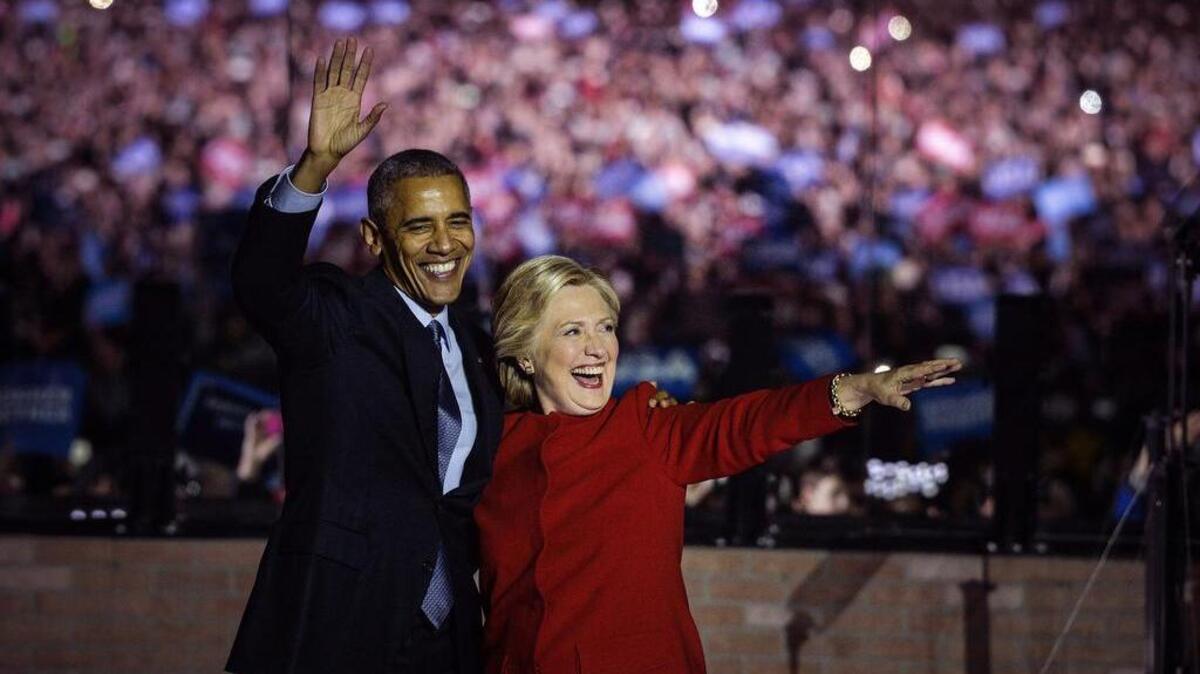 Hillary Clinton and President Barack Obama wave to the crowd during a pre-election campaign event in Philadelphia.