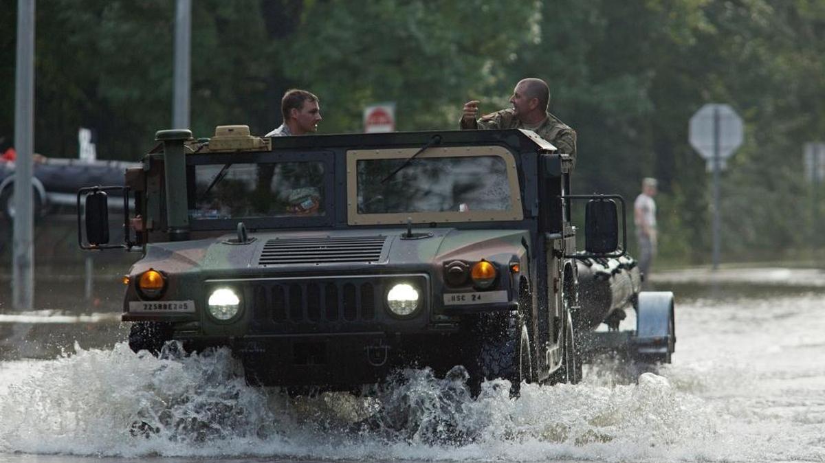 Army National Guard vehicles travel through floodwaters Aug. 14, 2016, on LA-442, west of Tickfaw, La., as rescue operations continue after heavy rains inundated the region.