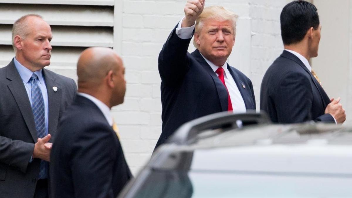 Republican presidential candidate Donald Trump waves as he arrives for a meeting with House Speaker Paul Ryan of Wisconsin, at the Republican National Committee headquarters on Capitol Hill in Washington, Thursday, May 12, 2016.