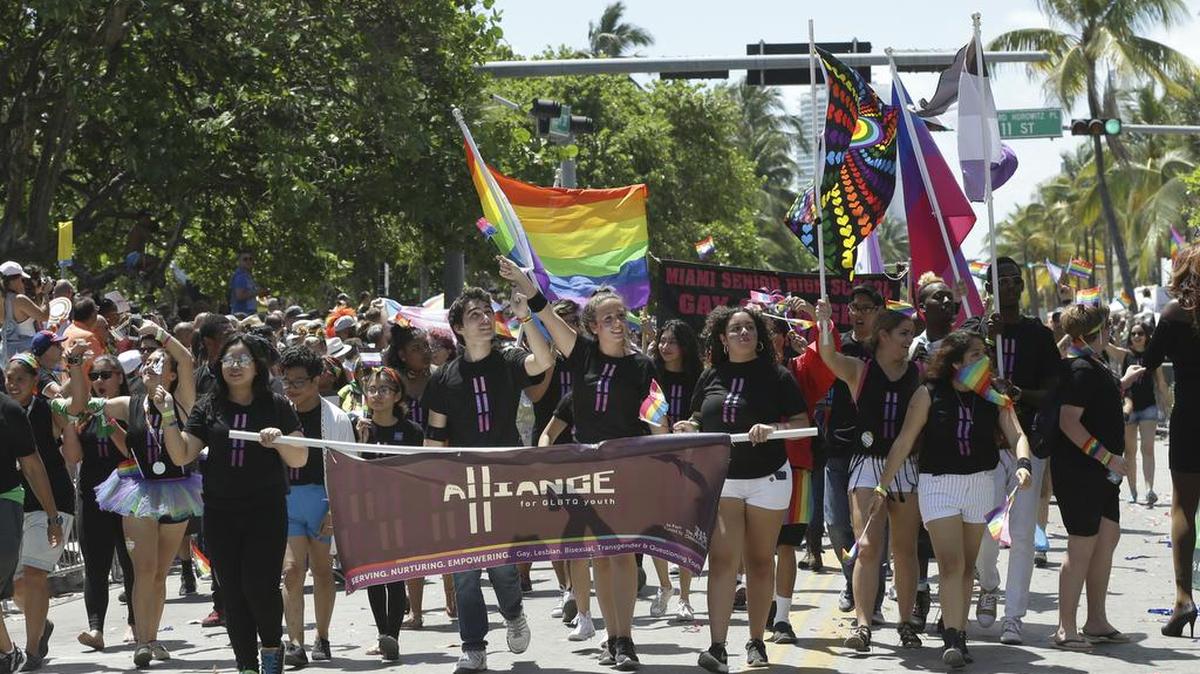 The Alliance of GLBTQ Youth marches during a parade along Ocean Drive at Miami Beach Gay Pride, Sunday, April 10, 2016.