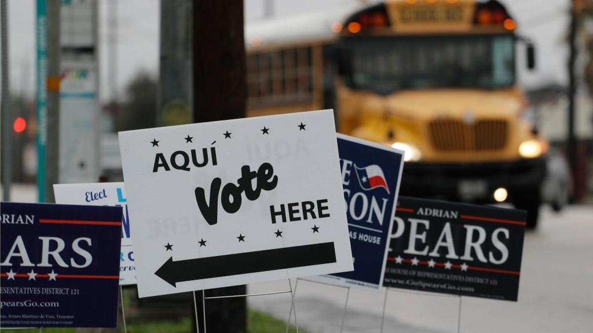Signs mark a polling site as early voting begins, in San Antonio. Democrats in Texas are early voting in bigger numbers ahead of the nation's first primary elections of the 2018 midterms.