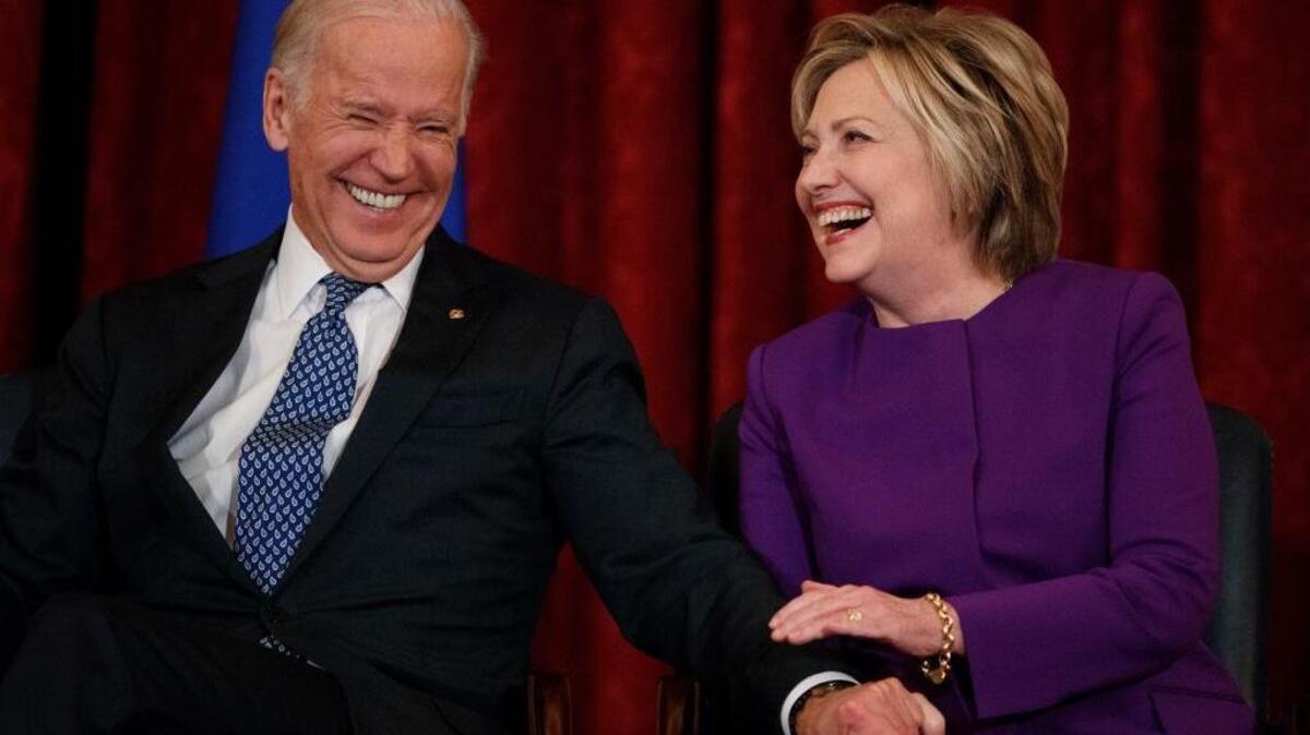 Vice President Joe Biden, left, laughs with former Secretary of State Hillary Clinton during a ceremony to unveil a portrait of Senate Minority Leader Harry Reid, D-Nev., on Capitol Hill, Thursday, Dec. 8, 2016, in Washington.