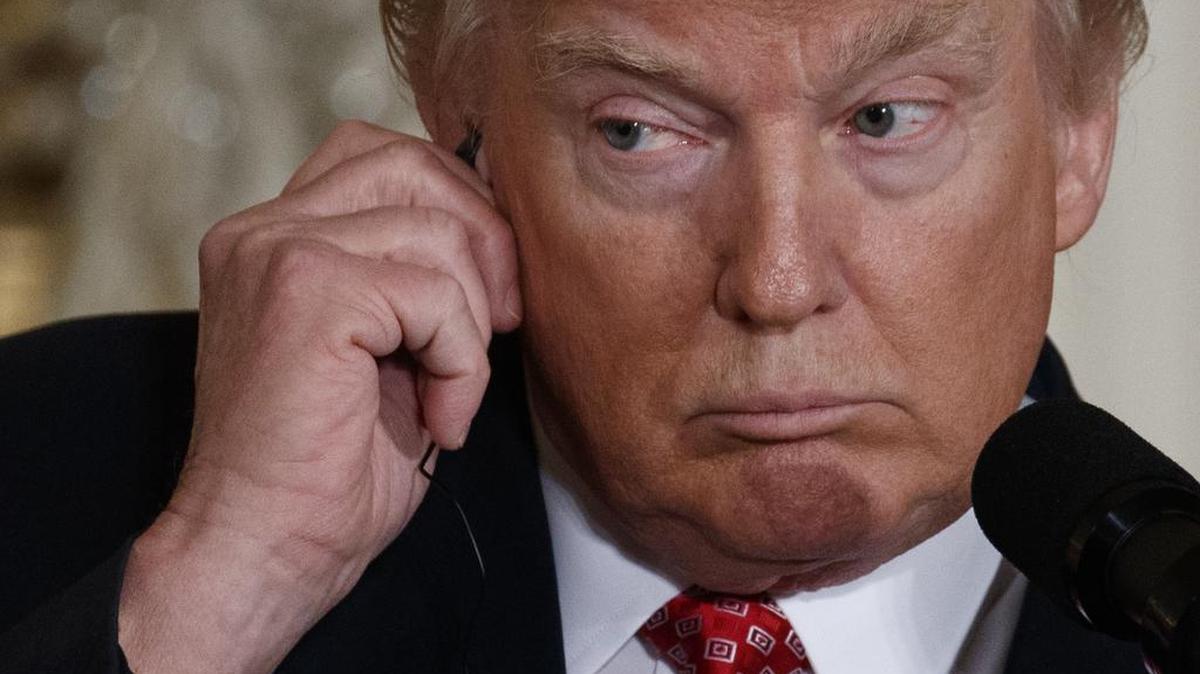 President Donald Trump listens to a translation as Japanese Prime Minister Shinzo Abe speaks during their joint news conference, Friday, Feb. 10, 2017, in the East Room of the White House in Washington.