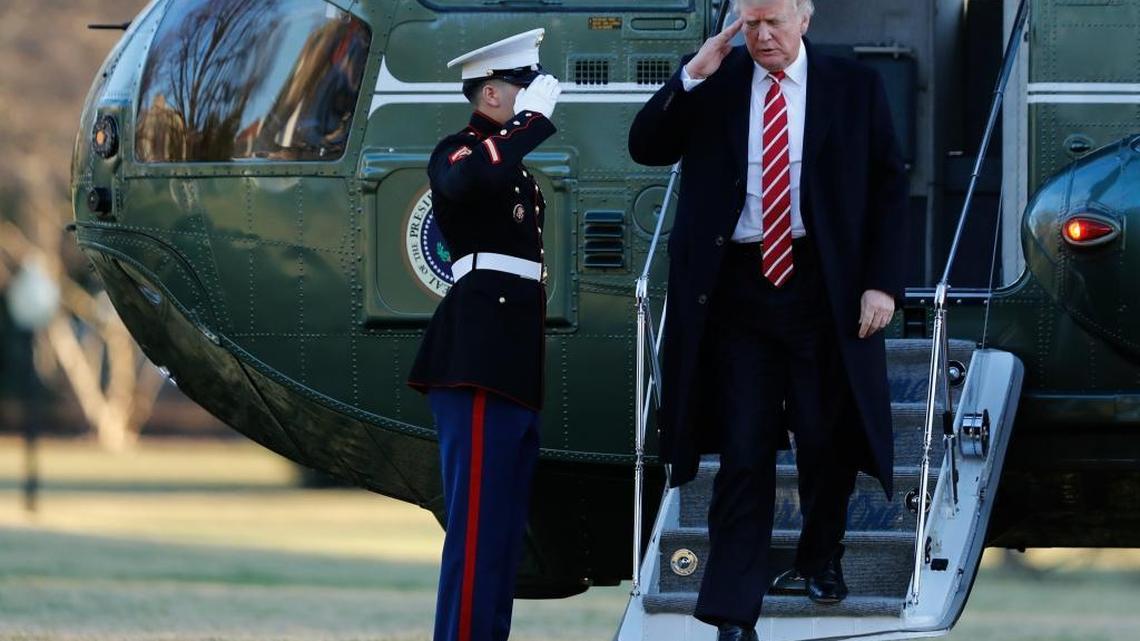 President Donald Trump salutes a Marines honor guard while he disembarks from Marine One, Monday, Feb. 6, 2017, as he returned to Washington from Florida.