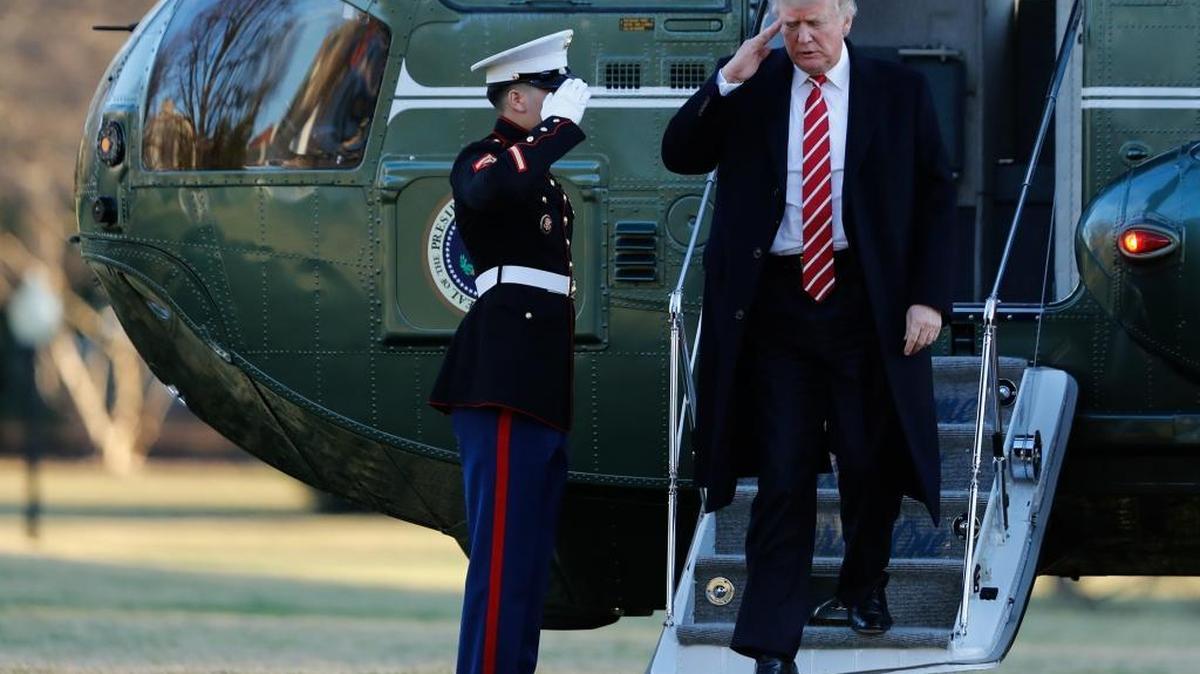 President Donald Trump salutes a Marines honor guard while he disembarks from Marine One, Monday, Feb. 6, 2017, as he returned to Washington from Florida.