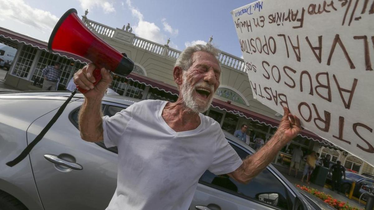 Eloy Angulo, 79, a former Cuban political prisoner, protests outside the Cafe Versailles in Little Havana on July 27, 2016.