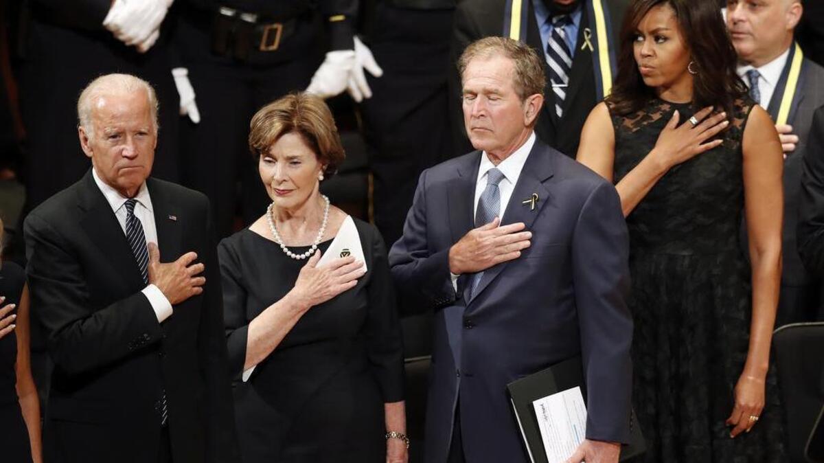 From left, Vice President Joe Biden, Laura Bush, former President George W. Bush, and first lady Michelle Obama stand during an interfaith memorial service for the fallen police officers and members of the Dallas community at the Morton H. Meyerson Symphony Center in Dallas on Tuesday.
