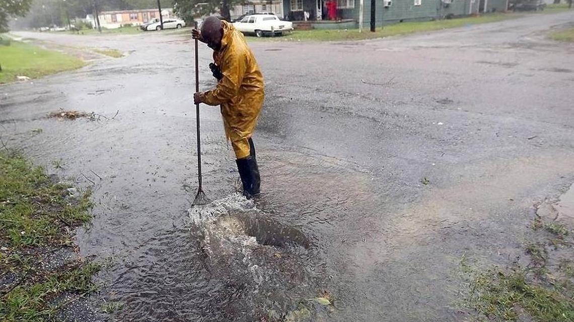 Tony Vanverhorst cleans a drain off Merriman Road in Georgetown on Saturday, Oct. 8, 2016. The city was bracing as Hurricane Matthew came up the East Coast as a category one.