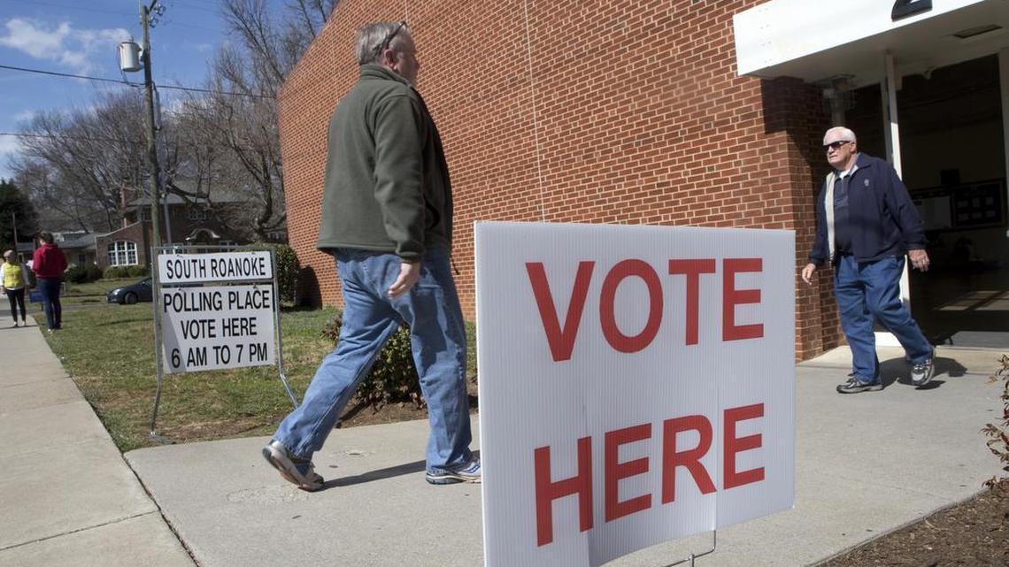 Voters enter and exit Crystal Spring Elementary School during the primary election on Tuesday, March. 1, 2016 in Roanoke, Va., Voters from Vermont to Colorado, Alaska to American Samoa and a host of states in between were heading to polling places and caucus sites on the busiest day of the 2016 primaries.