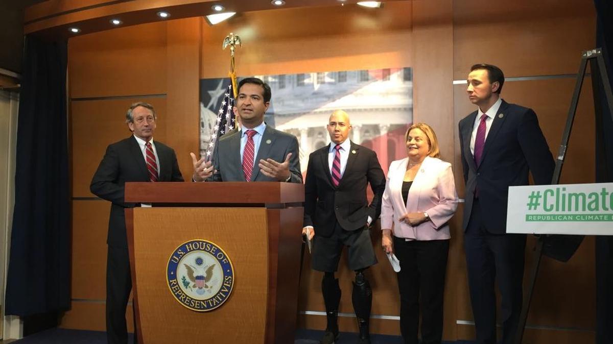 Rep. Carlos Curbelo, R-Fla., speaks to reporters at the Capitol about climate change on Monday, March 20, 2017. He is flanked by Republican Reps. Mark Sanford of South Carolina (from left), Brian Mast and Ileana Ros-Lehtinen of Florida and Ryan Costello of Pennsylvania.