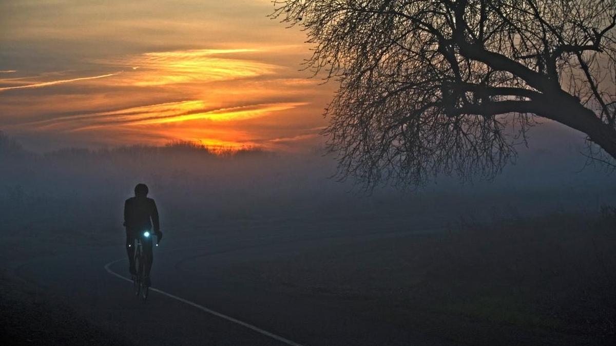 A cyclist on the American River Parkway bike trail at dawn. Several grants from the federal Land and Water Conservation Fund have helped create recreation facilities along the parkway, which runs between Sacramento and Folsom.