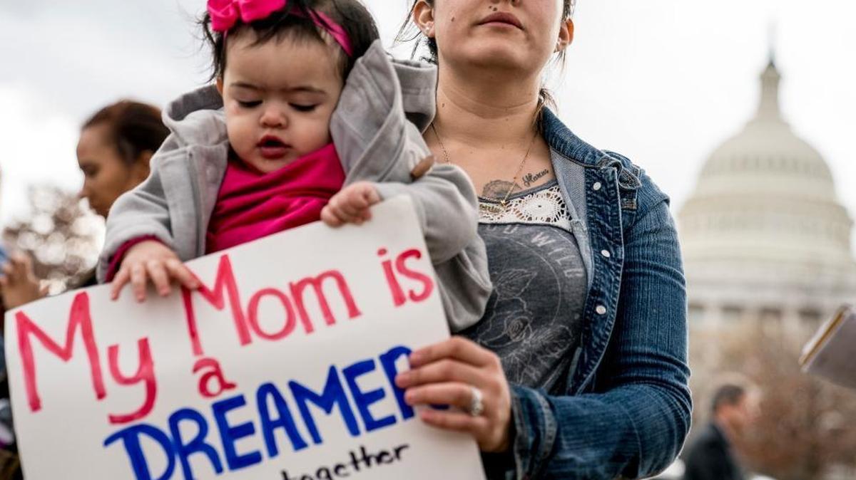 Yesenia Aguilar of Reading, Penn. holds her one year old daughter Denalli Urdaneta at an immigration rally on Capitol Hill in Washington, Tuesday, Jan. 23, 2018. Democrats and Republicans are re-launching the search for an immigration deal, fueled by fresh promises for a Senate vote, new concessions and good will after the agreement to reopen the federal government.