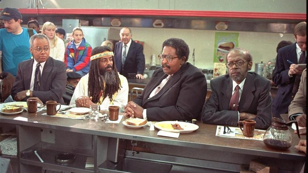 The four black men who were denied service at the Woolworth store in Greensboro, NC take their places at the same lunch counter to recreate their sit-in on Thursday, February 2, 1990. The men are (from left): Joseph McNeil, Jibreal Khazan (formerly Ezell Blair, Jr.), Franklin McCain, and David Richmond. (AP Photo/Chuck Burton)