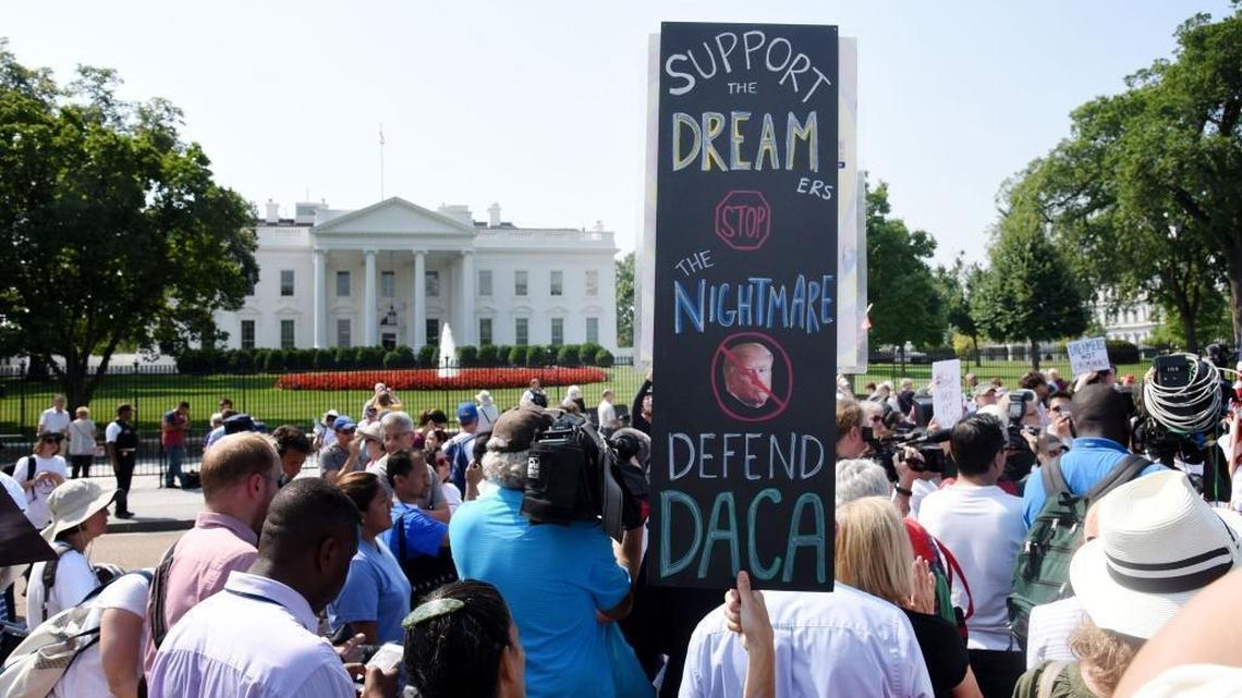 Protesters hold up signs during a rally supporting Deferred Action for Childhood Arrivals, or DACA, outside the White House. Thousands are expected to gather for rallies on Tuesday, when President Trump is slated to announce the future of the program.