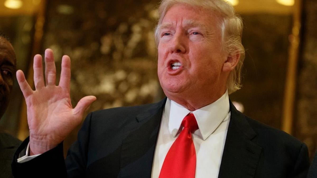 In this Jan. 13, 2017, file photo, President-elect Donald Trump speaks with reporters in the lobby of Trump Tower in New York.