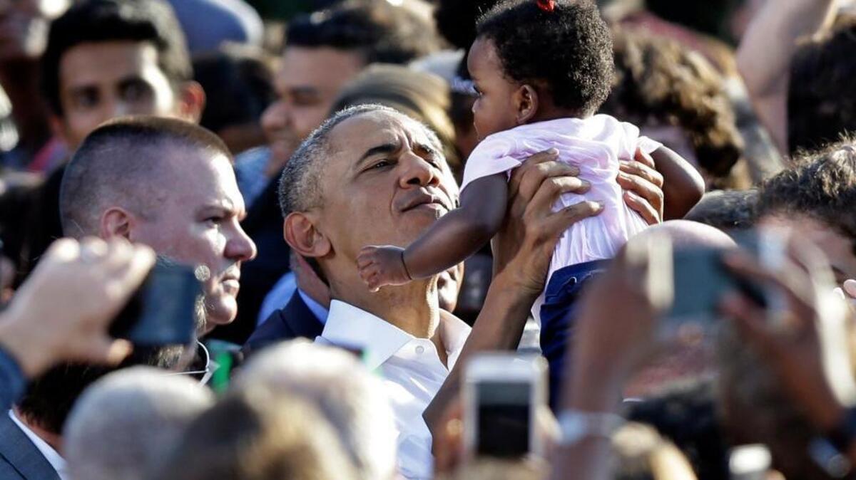 President Barack Obama holds a baby as he greets supporters while campaigning for Democratic presidential candidate Hillary Clinton in Chapel Hill, N.C., Wednesday, Nov. 2, 2016.