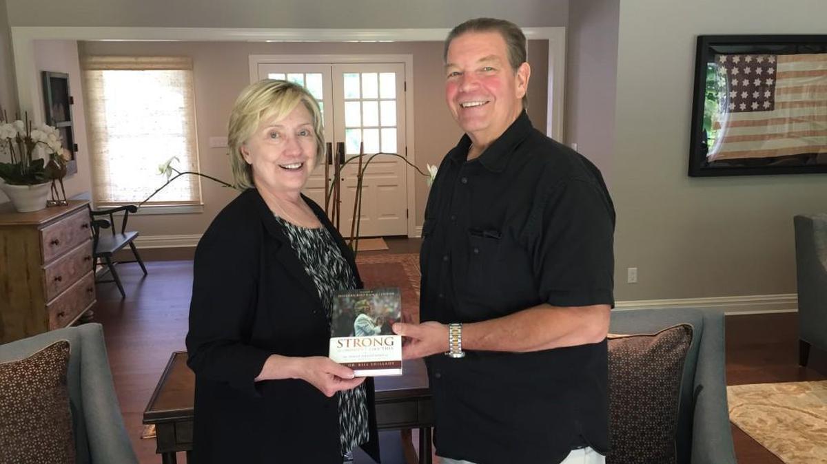 Hillary Clinton and the Rev. Bill Shillady with “Strong for a Moment Like This,” a book of devotionals Shillady and others wrote for Clinton during the 2016 presidential campaign.