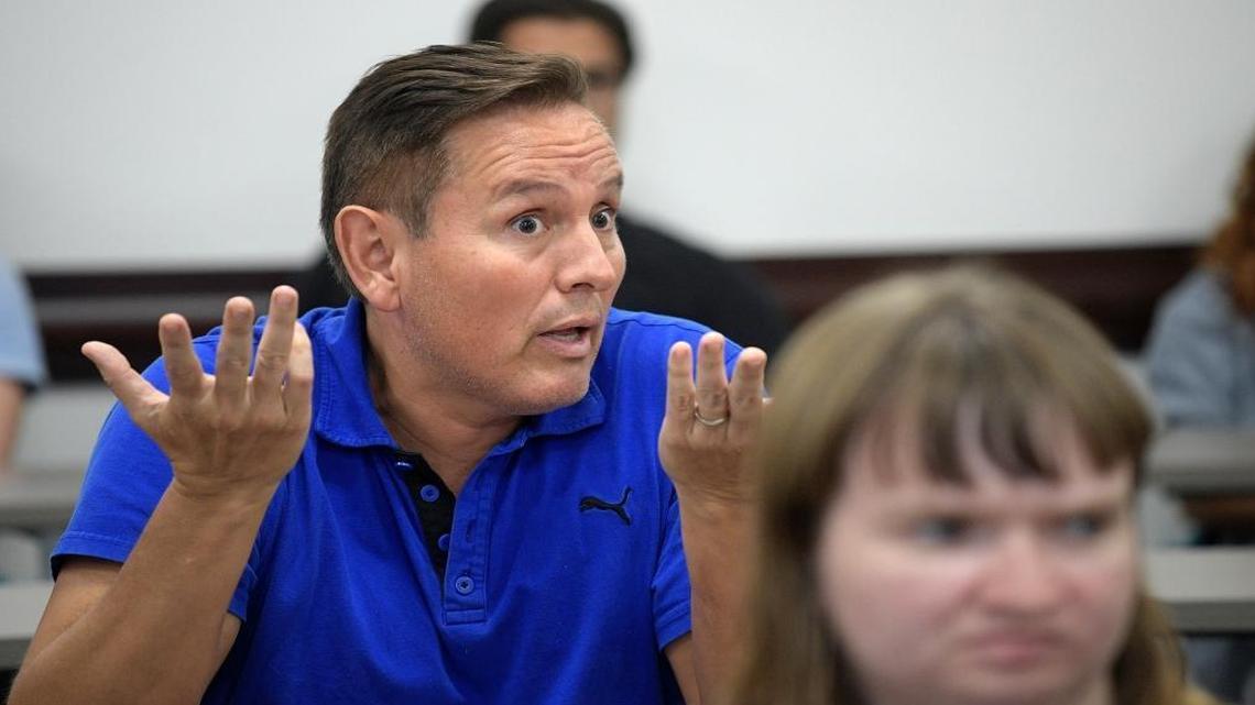 Democratic Presidential nominee Hillary Clinton supporter Julio Reynoso, left, gives his impressions of Republican Presidential nominee Donald Trump and Clinton after a campaign debate focus group viewing of the third Presidential debate in Orlando, Fla., on Oct. 22, 2016.