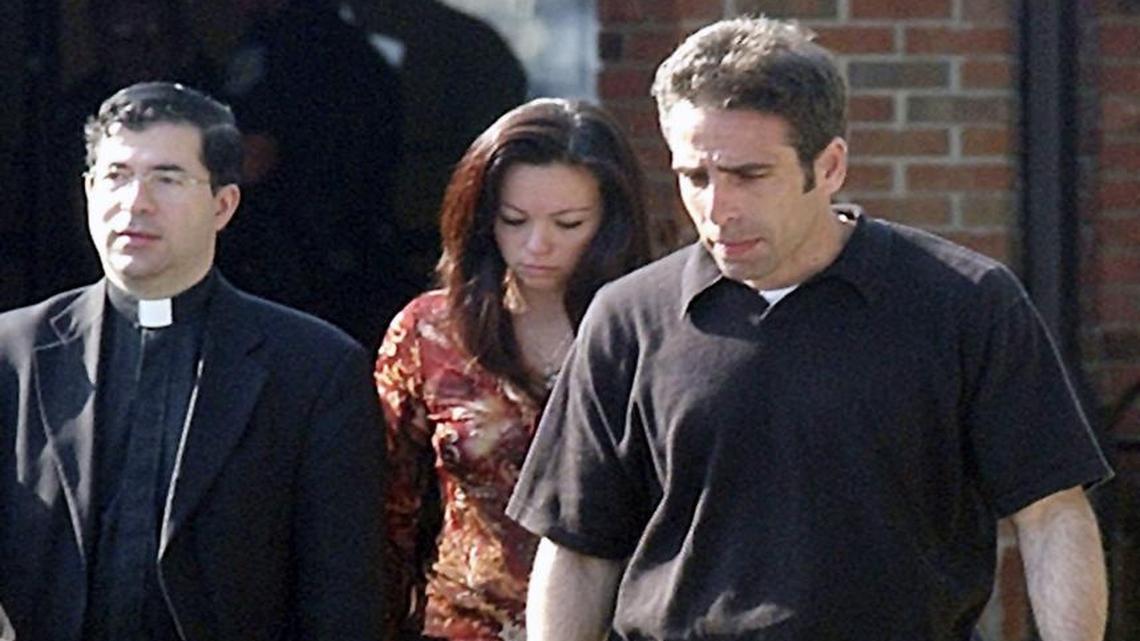 Father Frank Pavone, left, walks with Terri Schiavo’s brother Bobby Schindler, right, and sister Suzanne Vitadamo outside Woodside Hospice after visiting Schiavo on Thursday, March 31, 2005 in Pinellas Park, Fla. Pavone, head of an anti-abortion group called Priests for Life, is under fire after posting a video on Facebook featuring an aborted fetus on an alatar.