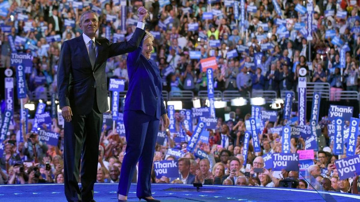 President Barack Obama, right, and Democratic presidential candidate Hillary Clinton, left, wave to the crowd following Obama's speech at the Democratic National Convention in Philadelphia, July 27, 2016.