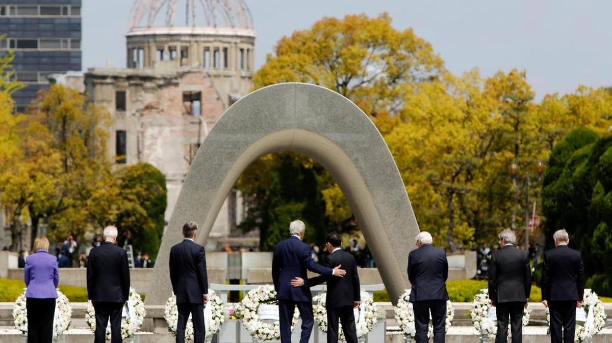 FILE - In this April 11, 2016, file photo, U.S. Secretary of State John Kerry, fourth from left, puts his arm around Japanese Foreign Minister Fumio Kishida after they and fellow G7 foreign ministers laid wreaths at the cenotaph at Hiroshima Peace Memorial Park in Hiroshima, western Japan. U.S. President Barack Obama will travel to Hiroshima in May 2016 in the first visit by a sitting American president to the site where the U.S. dropped an atomic bomb. Obama's visit will bolster his call for denuclearization and honor victims of the bombing that killed 140,000 Japanese on Aug. 6, 1945. The president's visit had long been anticipated.