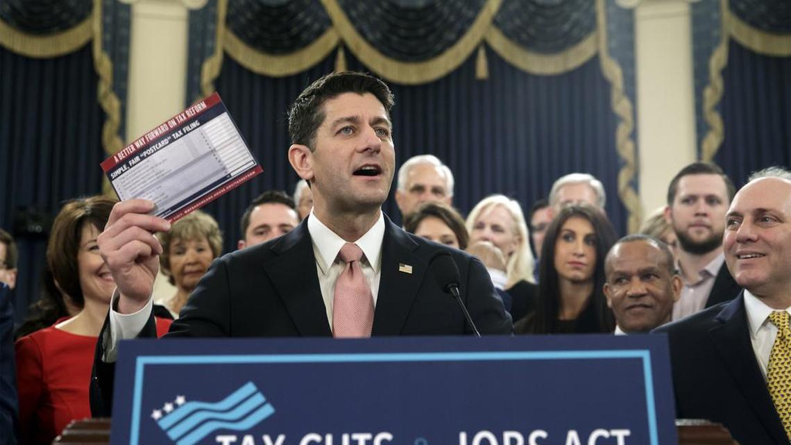 Speaker of the House Paul Ryan, R-Wis., with House Majority Whip Steve Scalise, R-La., far right, holds a proposed “postcard tax filing form” as they unveil the GOP’s far-reaching tax overhaul, the first major revamp of the tax system in three decades, on Capitol Hill in Washington, Thursday.