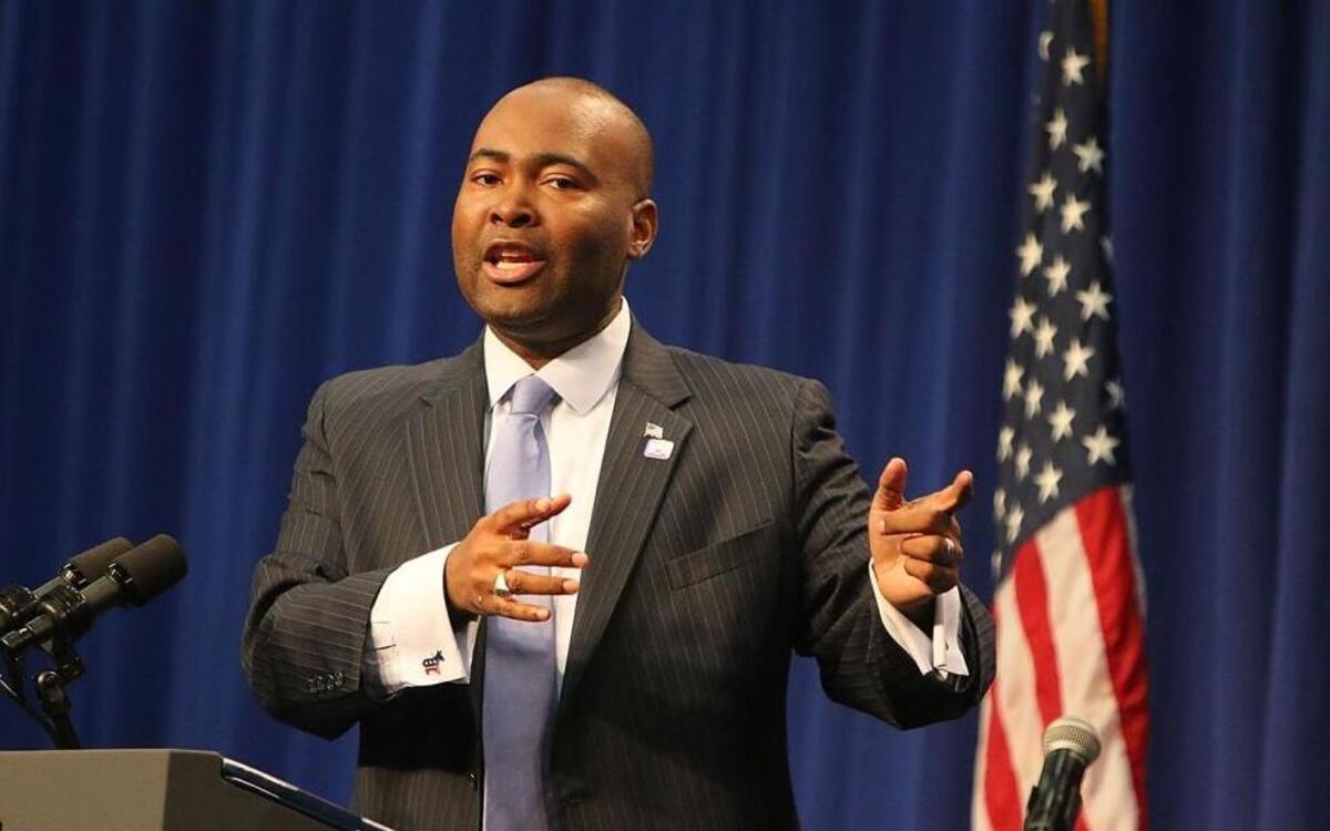 The SCDP chair, Jaime Harrison, introduces Congressman James Clyburn. at a Democratic Rally held on Allen University's campus in Columbia, S.C., Oct. 14, 2014.
