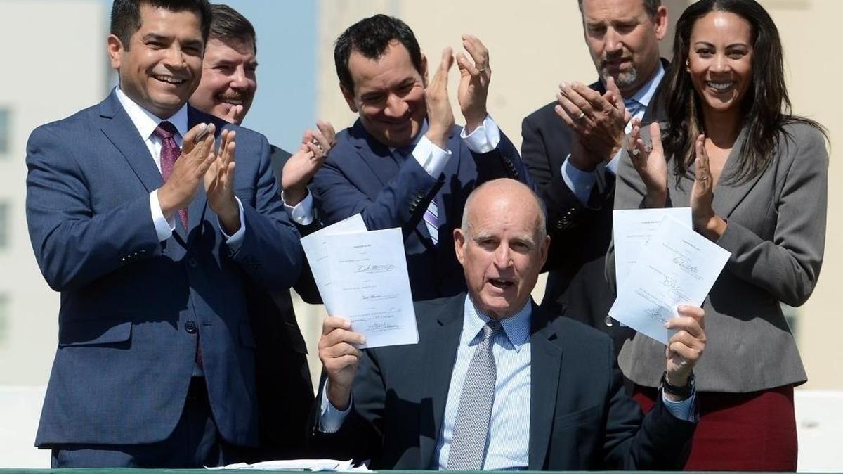 California Gov. Jerry Brown in September displaying bills he signed related to climate change.