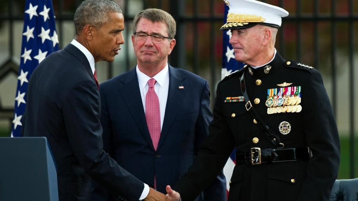 President Barak Obama shakes hands with Marine Corps Gen. Joseph Dunford, the chairman of the Joint Chiefs of Staff, as Secretary of Defense Ashton Carter looks on after delivering remarks at the Sept. 11 memorial observance ceremony at the Pentagon on Sunday, Sept. 11, 2016.