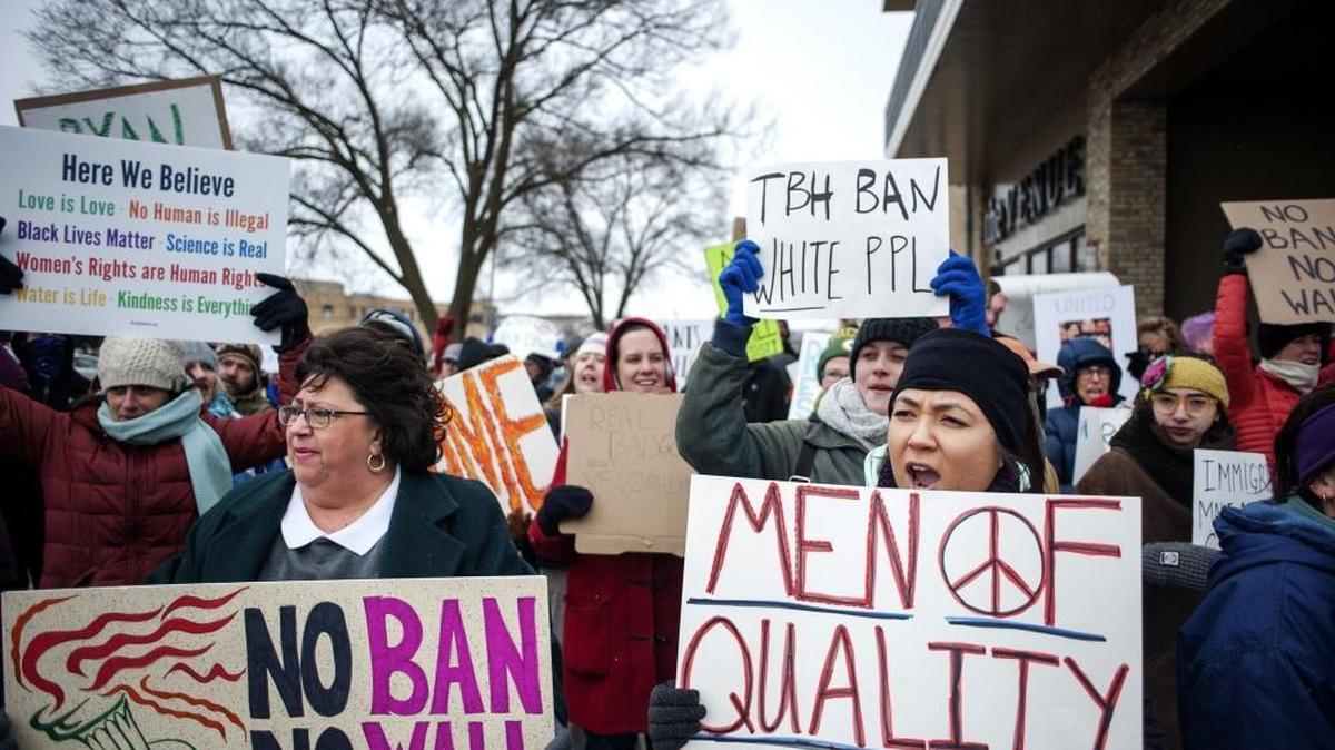 Protesters denounce President Donald Trump's immigration orders in Janesville, Wis.