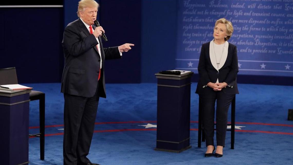 Democratic presidential nominee Hillary Clinton listens to Republican presidential nominee Donald Trump during the second presidential debate at Washington University, Sunday, Oct. 9, 2016, in St. Louis.