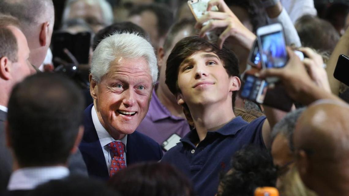 Former President Bill Clinton, left, poses for a selfie as he campaigns for his wife, Democratic presidential candidate Hillary Clinton, Wednesday, Sept. 7, 2016, at Dr. James R. Smith Neighborhood Center in Orlando, Fla.