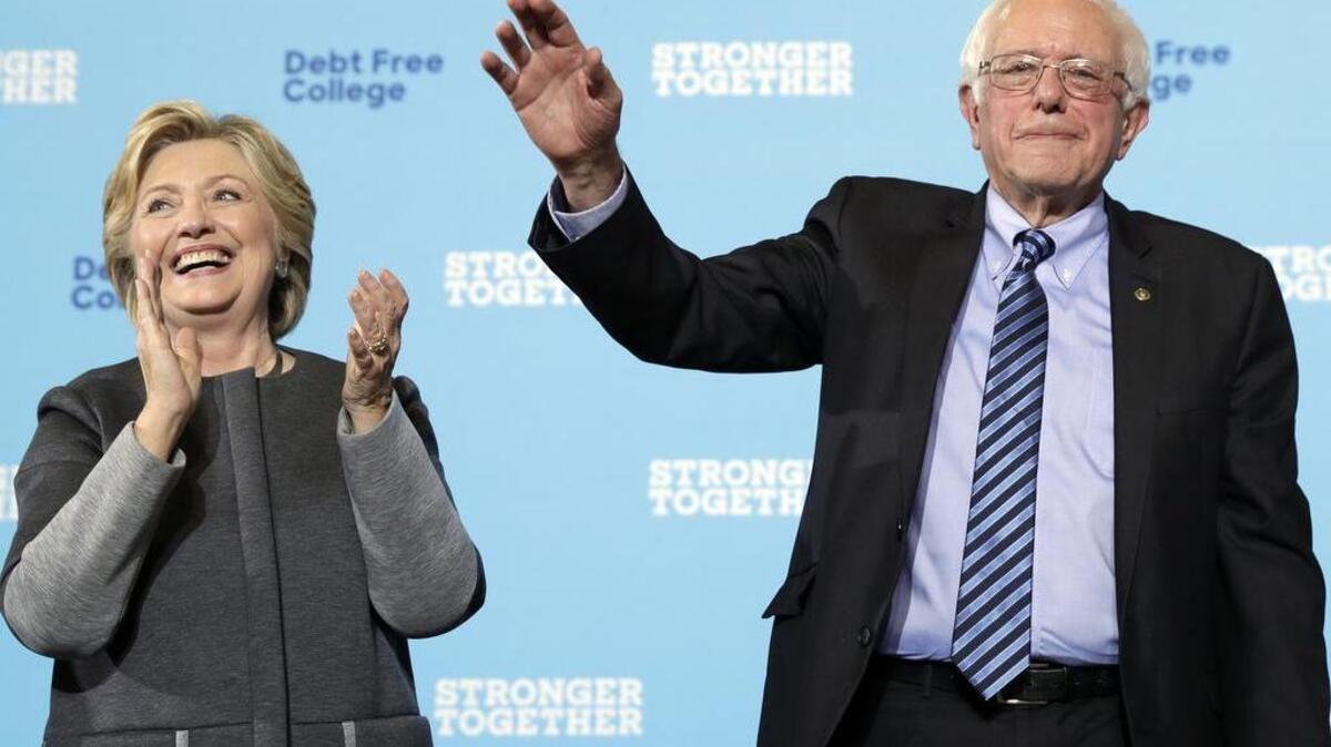 Democratic presidential candidate Hillary Clinton and Sen. Bernie Sanders, I-Vt. acknowledge the audience at a campaign stop at the University Of New Hampshire in Durham, N.H., Wednesday, Sept. 28, 2016.
