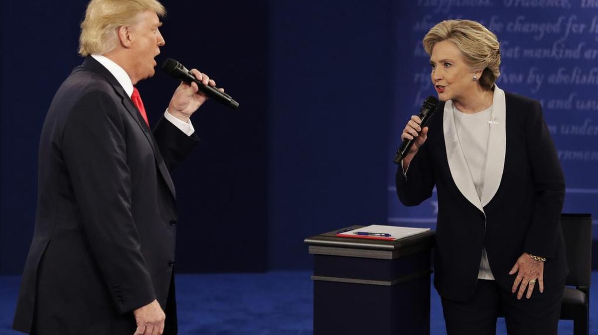 Republican presidential nominee Donald Trump and Democratic presidential nominee Hillary Clinton speak during the second presidential debate at Washington University in St. Louis on Sunday, Oct. 9, 2016.