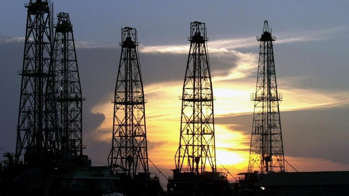 In this Aug. 1, 2004, file photo, the sun sets behind an oil drilling rig near Cabimas, Venezuela. Congress is divided over a ban on Venezuelan oil imports ahead of a July 30 election that could dramatically alter the Venezuelan constitution.