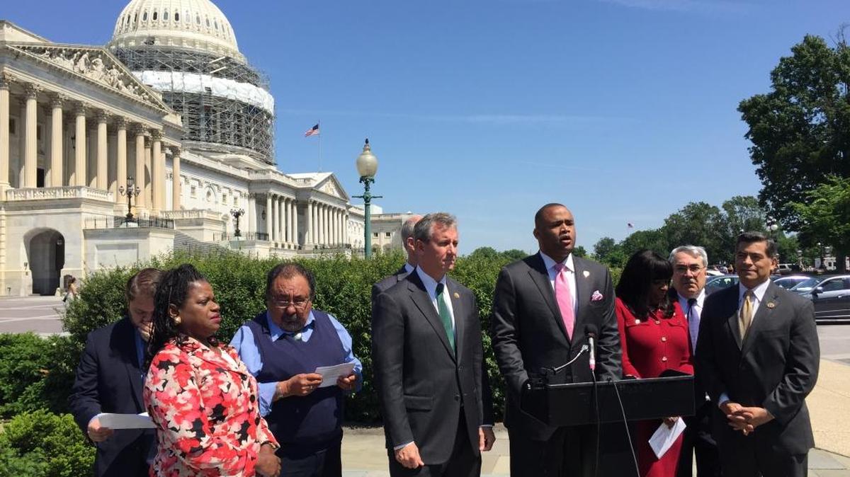 Rep. Marc Veasey, D-Texas, at podium, confers with other Democratic House members in Washington on May 24, 2016. Veasey and about a dozen members announced the formation of the Congressional Voting Rights Caucus to promote an update of the Voting Rights Act. The Supreme Court struck down key provisions in 2013.