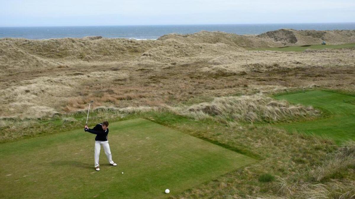 Local resident Isaac Lennox drives off the tee in May. Trump International Golf Links sits among sand dunes on the Scottish coast north of Aberdeen. Donald Trump opened the course in 2012, despite the steady complaints of neighbors.