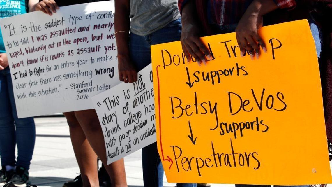 People gather to protest proposed changes to Title IX before a speech by Education Secretary Betsy DeVos, Thursday.