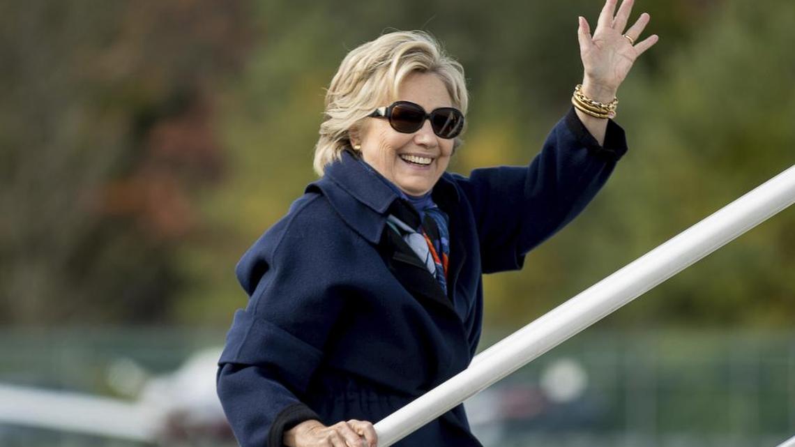 Democratic presidential candidate Hillary Clinton waves as she boards her campaign plane at Westchester County Airport in White Plains, N.Y., Saturday, Oct. 29, 2016, to travel to Florida.