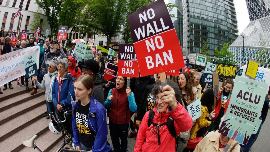 Protesters wave signs and chant during a demonstration against President Donald Trump’s revised travel ban on May 15, 2017, outside a federal courthouse in Seattle.