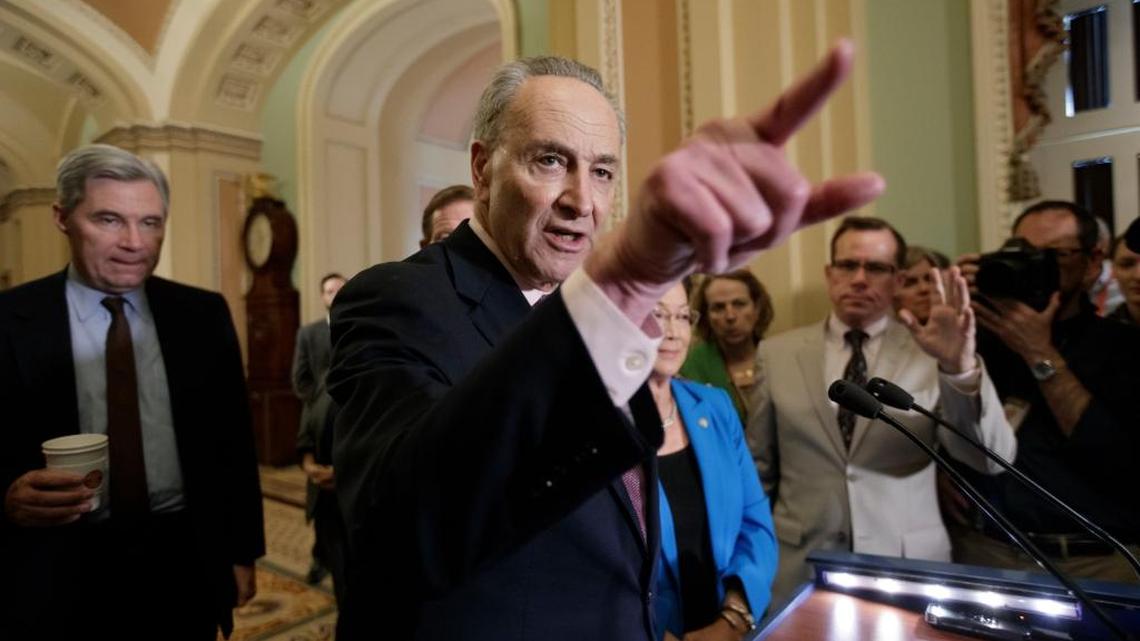 Senate Minority Leader Charles Schumer, D-N.Y., joined at rear by Sen. Sheldon Whitehouse, D-R.I., and Sen. Mazie Hirono, D-Hawaii, speaks to reporters on Capitol Hill in Washington.