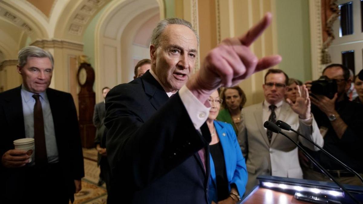Senate Minority Leader Charles Schumer, D-N.Y., joined at rear by Sen. Sheldon Whitehouse, D-R.I., and Sen. Mazie Hirono, D-Hawaii, speaks to reporters on Capitol Hill in Washington.