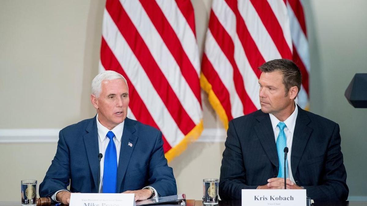 Vice President Mike Pence, left, accompanied by Vice-Char Kansas Secretary of State Kris Kobach, right, speaks during the first meeting of the Presidential Advisory Commission on Election Integrity at the Eisenhower Executive Office Building on the White House complex in Washington, Wednesday, July 19, 2017.