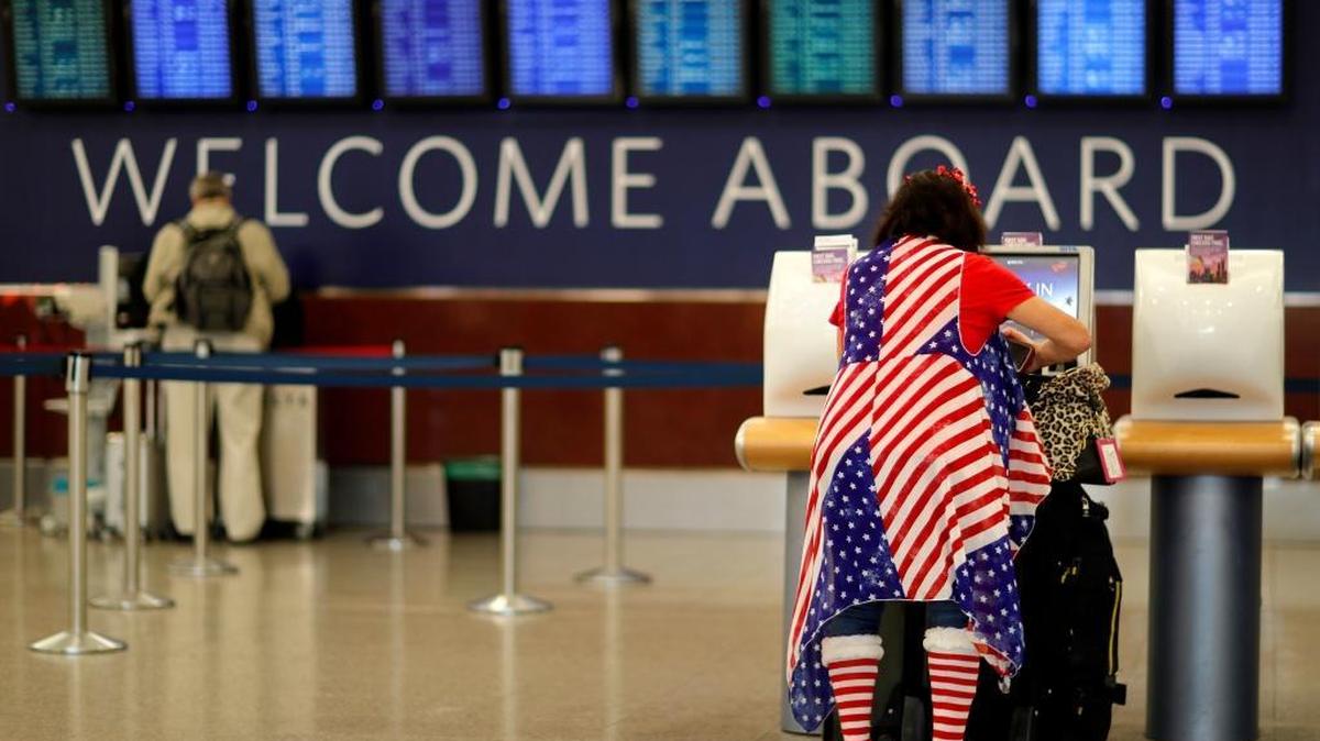 Judy Izzie, dressed in the theme of the American flag, checks in for her flight at Hartsfield-Jackson Atlanta International Airport.