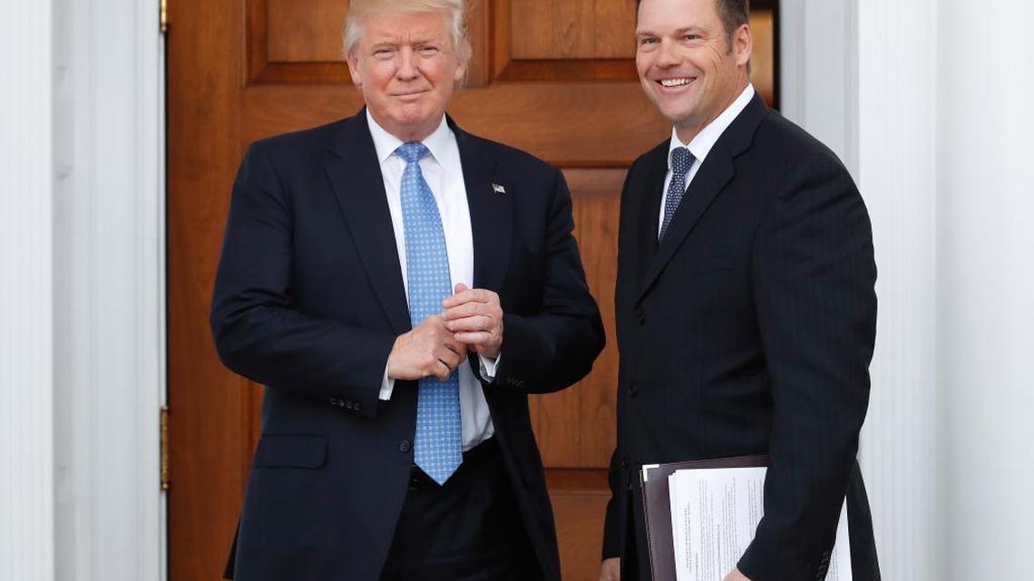 President-elect Donald Trump pauses for photographs as he greets Kansas Secretary of State Kris Kobach at the Trump National Golf Club Bedminster clubhouse, in Bedminster, N.J., on Nov. 20, 2016.